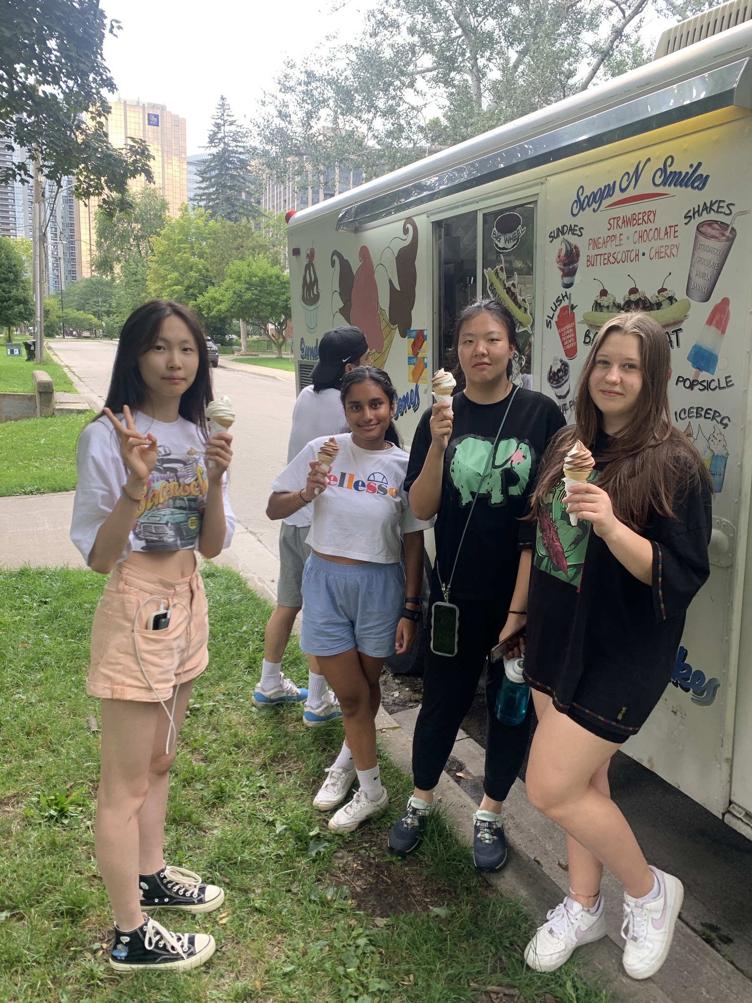 Students standing in front of ice cream truck holding ice cream Open Gallery